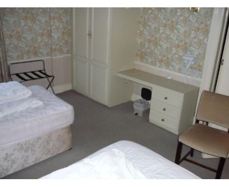 The bedroom contents of room 25, comprising of two single beds, pair of three drawer chests, chairs, luggage rack, fixed bedr
