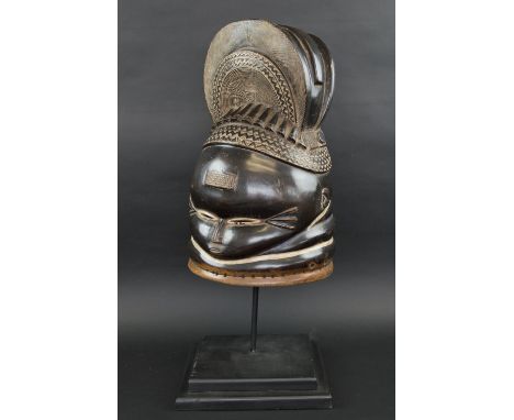MENDE HELMET MASK carved wood with traces of paint, 48cm H, plus a display stand.