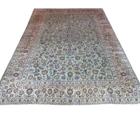 FINE KASHAN CARPET, 402cm x 290cm, central medallion on a jade field of palmettes and vines within a repeat palmette old gold