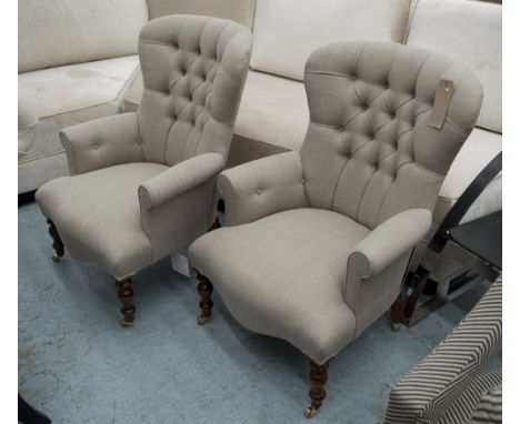ARMCHAIRS, a pair, in neutral fabric button back on turned castor supports, 66cm W. (2)