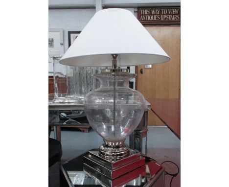 ANDREW MARTIN TABLE LAMP, urn shaped in glass on chromed metal supports with shade, 82cm H.