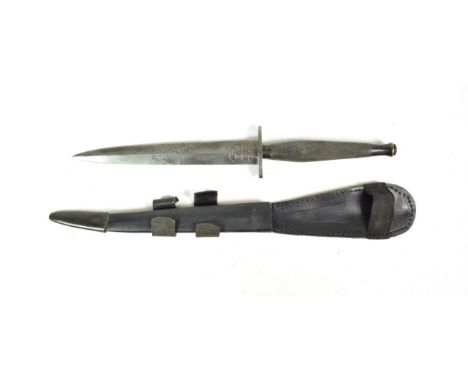 A Fairbairn Sykes F.S. Fighting Knife, second pattern, the 17.5cm double edge hand forged steel blade with recessed panel etc