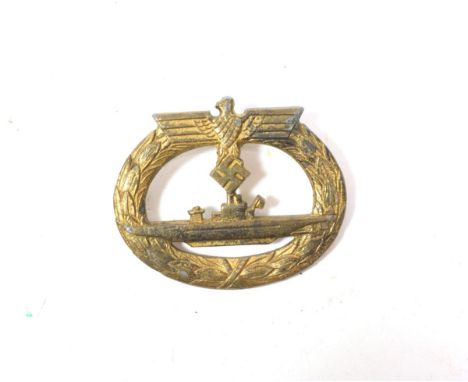 A German Third Reich U-Boat War Badge, in gold washed metal, the reverse indistinctly marked, lacking the vertical needle pin