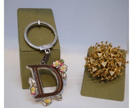 1. DIOR. Leather and metal bag accessories, iconic "D" and painted enamel metal flowers. 2. HENKEL & GROSSE. Golden metal bro