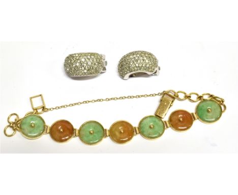 A CHINESE JADEITE PANEL BRACELET in the form of alternate mottled-green and brown round discs, each centrally pierced with a 