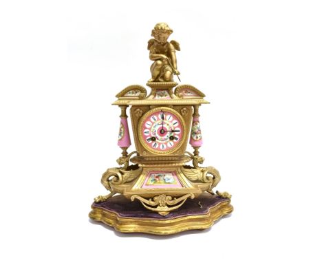 A FRENCH PORCELAIN AND GILT METAL MOUNTED MANTLE CLOCK  surmounted by cherub, the 8-day movement striking on a bell, signed '