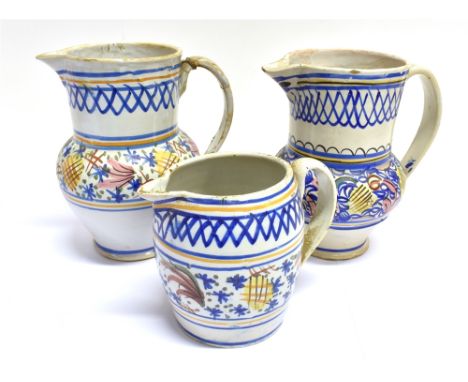 A 19TH CENTURY FRENCH FAIENCE TIN GLAZED BALUSTER SHAPED PITCHER  with red, blue, yellow and pink decoration, 22.5cm high; to