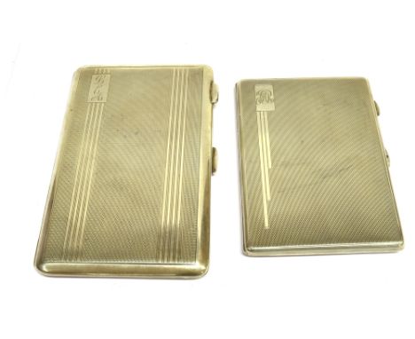 TWO EARLY 20TH CENTURY ENGINE TURNED RECTANGULAR CIGARETTE CASES each stamped 'Sterling Silver'; one with engine turned bands