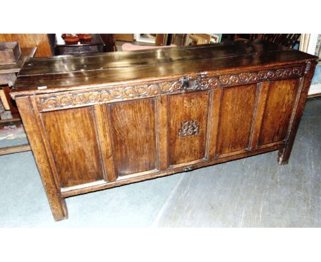 A LARGE JOINED OAK COFFER  the five panel front carved 'MH 1661' to central panel, on stile feet, 167cm long 59cm deep 80cm h