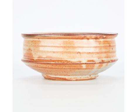 Warren MacKenzie (American, 1924-2018). Studio ceramic serving bowl. Shino glazed stoneware, marked along the footrim.Warren 