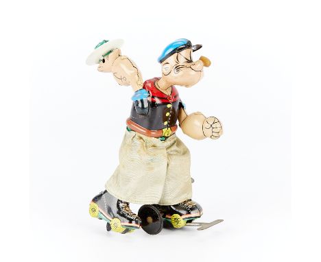 Marx Linemar lithographed tin wind-up toy depicting Popeye the Sailor Man on roller skates holding aloft a tin of spinach on 