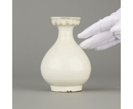 Chinese white glazed Yingqing ware ceramic vase, possibly Tang Dynasty. With a round body and a flared rim with applied decor