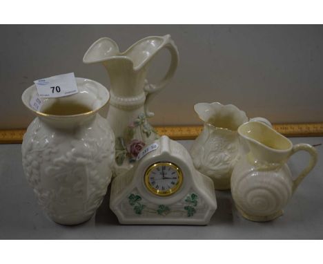 Collection of Belleek porcelain wares comprising three jugs, a mantel clock and vase
