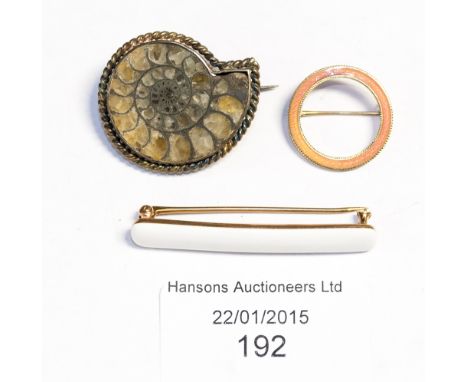 A white enamel bar brooch, stamped 14k, 4.5cm wide; a pink enamel circular brooch stamped 14k; and an ammonite brooch (3)