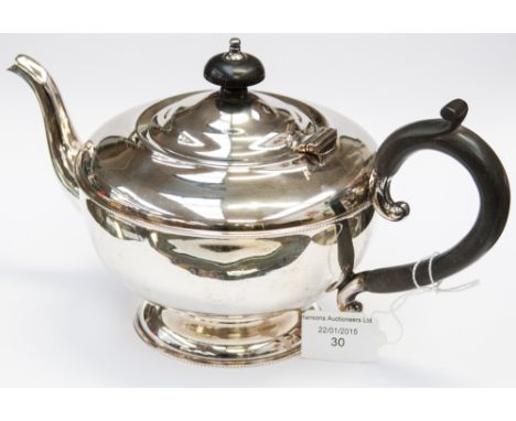 A George III style silver teapot, Birmingham 1930, makers mark for William Suckling, the lid with an ebony knob finial, with 