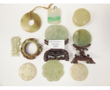 A collection of Oriental jade, including carved roundels, a small pill box, a pendant, plus various others
