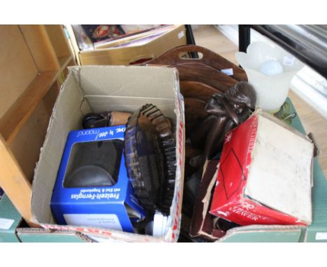 A box containing a collection of items, including a letter rack, a bisque headed doll, lamp, soapstone carving of a head, plu