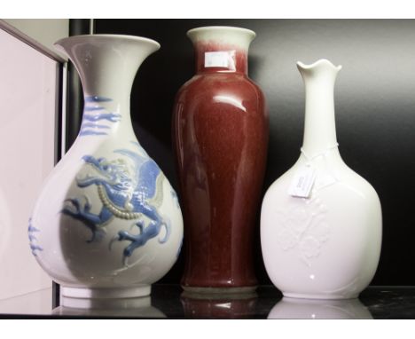 A Royal Copenhagen blanc de Chine vase together with a Lladro Chinese Dragon vase and an Oriental shouldered vase (3)