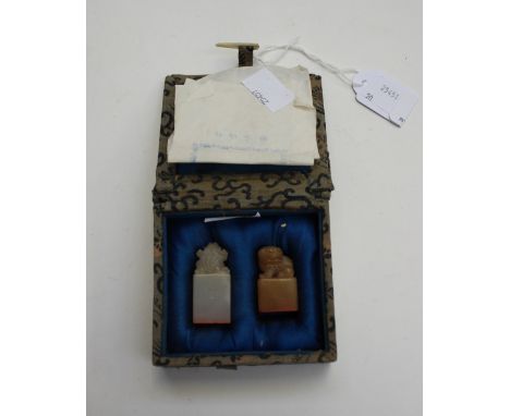 A Chinese boxed set of two jade seals, each with embossed character marks to undersides