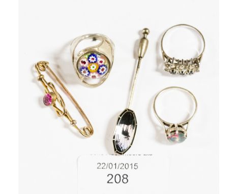 A collection of assorted jewellery, comprising a yellow metal brooch set with a ruby coloured stone, a silver moonstone ring,