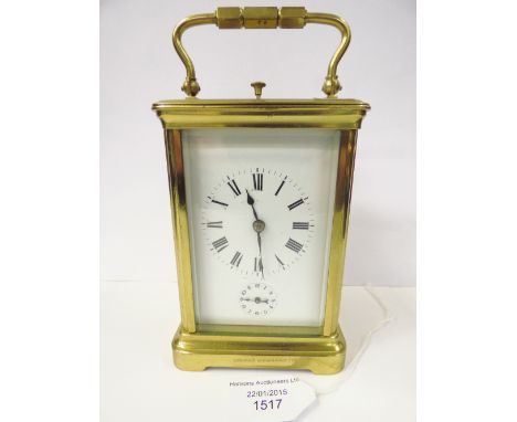 An early 20th Century French carriage clock with subsidiary dial brass cased enamel Roman numeral dial 