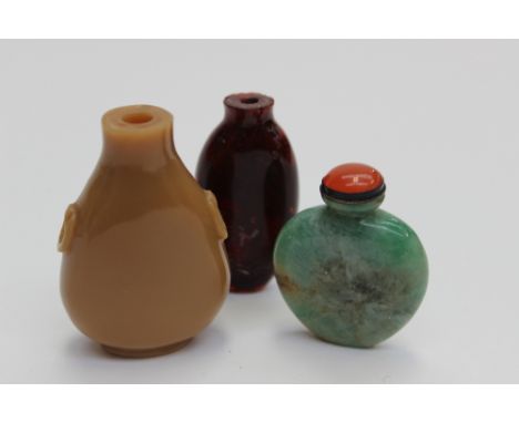 Three various Oriental scent bottles, comprising one in deep red, one in tan brown and a green jade small scent bottle, (3)
