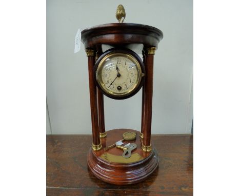 An early 20th Century mantle clock of portico form, French movement with enamelled dial, presentation inscription dated 1913