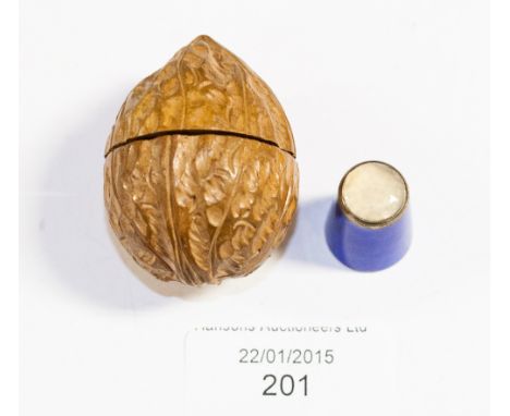 A carved wood nut shape thimble case, with velvet interior, together with a Norwegian silver blue enamelled thimble (enamel a
