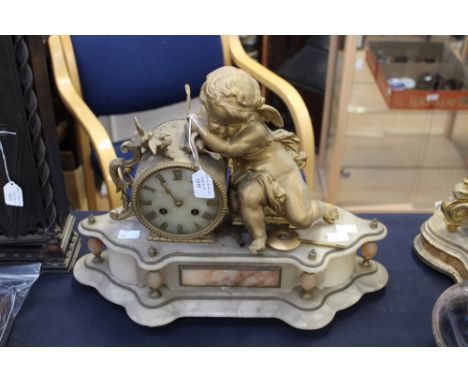 A late 19th Century onyx and gilt metal mantel clock, with a cherub sitting next to the circular dial, on a shaped wavy base 