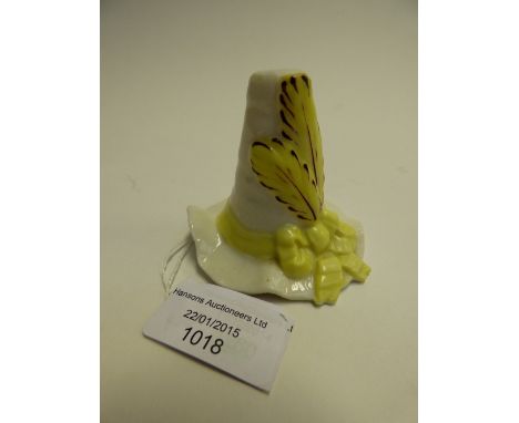 A Worcester Grainger and Co candle snuffer in the form of a Welsh hat with yellow feather and ribbon 