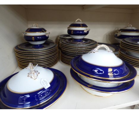 An extensive Copeland Spode dinner service, white with blue and gilt banding, comprising various plates, tureens, platers and