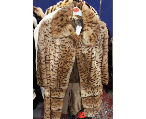 A vintage Ocelot fur coat with inner swing ties, self lined collar, horizontal leather patterning above the hem 