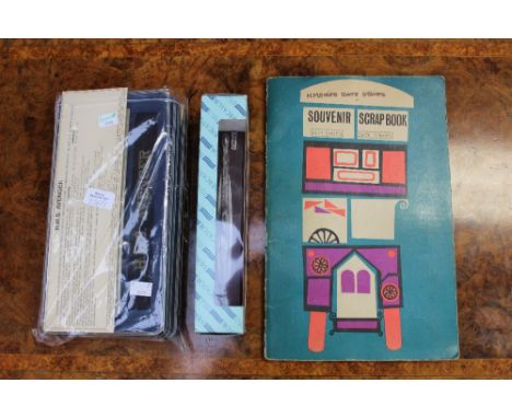 A souvenir scrapbook containing HM ships postal date stamps, a Mercantor cast metal A-CLA submarine boxed, together with Navy