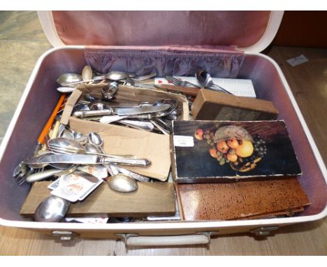 A suitcase of playing cards, cribbage boards and cutlery (good quantity) 