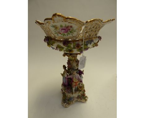 A late 19th Century German centrepiece, the base encrusted with flowers and pierced panels, the floral encrusted stem with fi