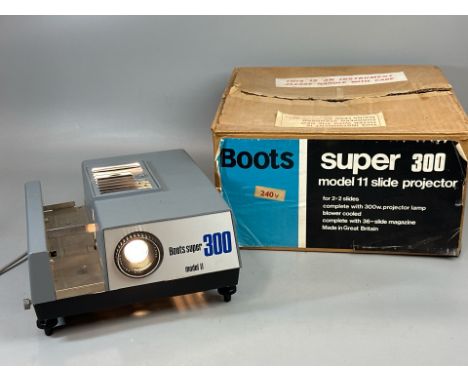 A Boots 'Super 300' model 11 slide projector with original box, missing slide tray, powers up not fully tested / T32