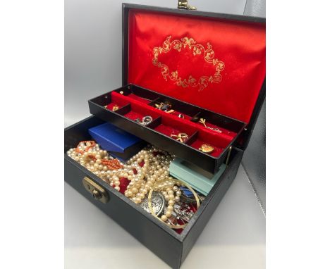 A jewellery case containing mostly costume jewellery including a coral bead necklace, a gold plated opal pendant and chain, a