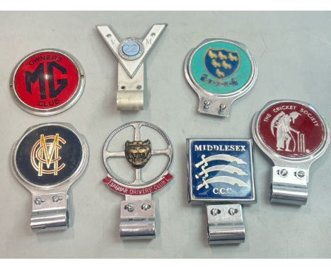 Seven vintage car badges including Jaguar Drivers Club, MG Owners Club, Veteran Motorist, MCC (Marylebone Cricket Club), Suss