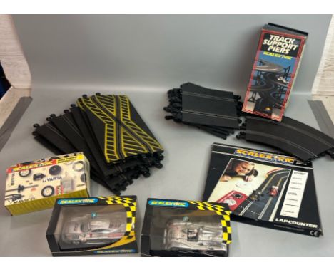 Scalextric part set including two boxed cars, lapcounter, track support piers, race tuning accessories and track (Lot subject