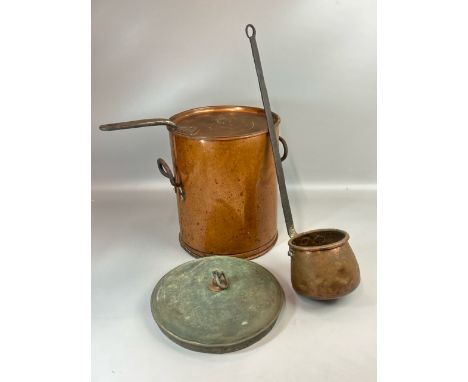 A large antique copper two handled cooking pot, 31cm high, 26cm diameter; with two lids and a large copper ladle with cast ir