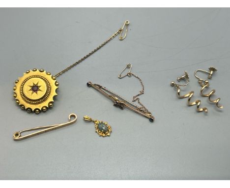Five items including an antique circle brooch with locket back testing as 15ct gold with base metal pin, gross weight 9g, som
