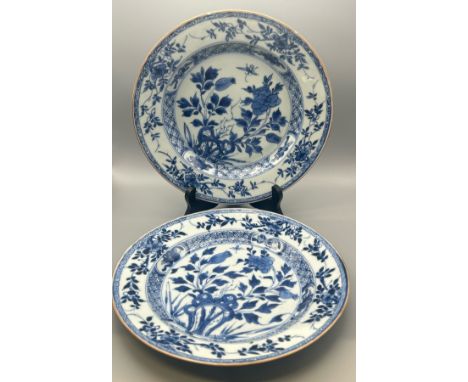 A pair of Kangxi period blue and white shallow bowls decorated with flowers, both 23.5 cm diameter, 2.5cm high / T27
