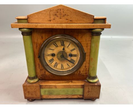Antique clock in light wooden case with green painted columns, brass movement and key, in need of restoration, though alarm b