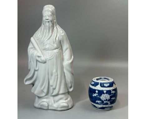 A Chinese blanc de chine figure of a wise man, 25cm high and a small blue and white prunus pattern jar with cover / T28