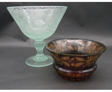 An antique Bohemian amber flashed ruby uranium cut glass bowl with engraved floral and foliate design and star cut base along