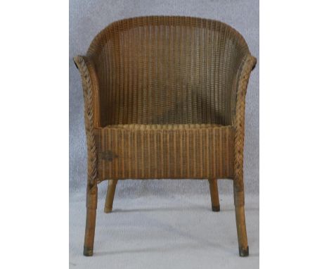 A vintage Lloyd Loom woven tub armchair with maker's label to the underside. H.70cm 