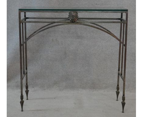 A Neoclassical style wrought iron console table with plate glass top. H.75.5 L.76 W.29cm 