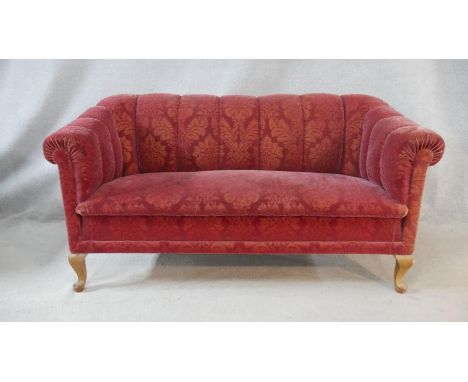 A two seater Chesterfield style sofa in cut floral upholstery on cabriole supports. H.80 W.160 D.80cm 