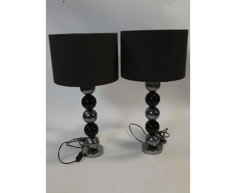 A pair of contemporary bobbin design table lamps with black shades. H.63cm.
Open 7 days for viewing 10am to 6pm.