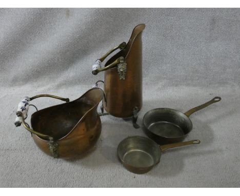Two matching copper coal scuttles with blue and white ceramic handles along with two vintage copper saucepans. H.43 (Tallest)
